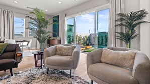 A modern living room with two sofas, a coffee table, and a dining area. - Brand new luxury home near Tahquitz Creek Golf Course with mountain views! (Palm Springs)