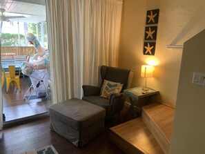 Relax in a well-appointed room with a cozy seating area, featuring a cushioned bench and armchair, perfect for unwinding.