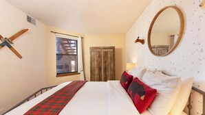 A bedroom with a bed, a window, a wardrobe, and a mirror on the wall. - Frisco Gateway to Skiing: Min to Breck + Keystone, Hot Tubs, Pickleball, Sauna (Frisco)