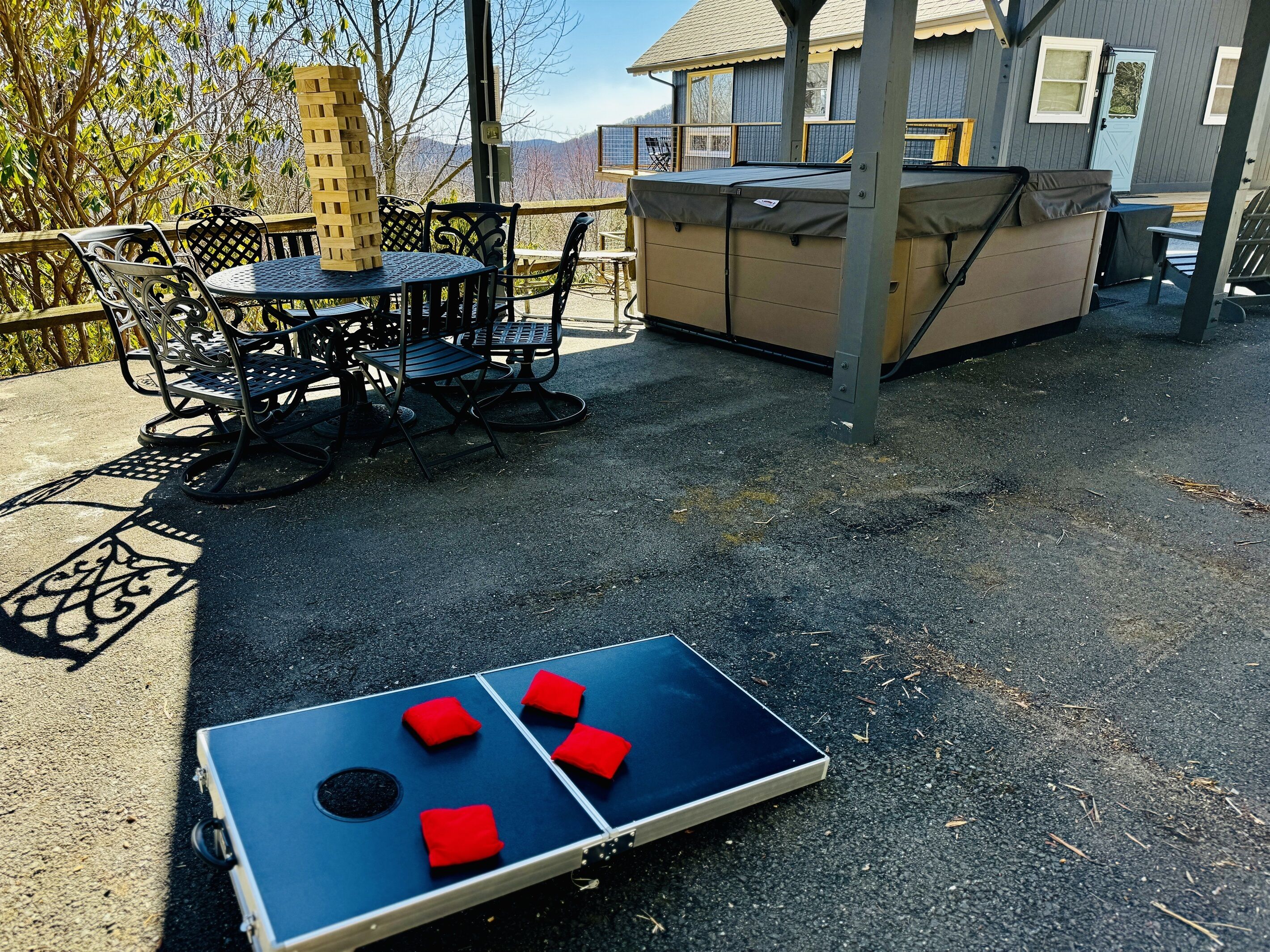 A patio area with a foosball table, outdoor seating, and a covered play area.