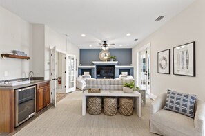 A modern living room with a fireplace, a sofa, and a coffee table. - New Beachcombers @ Luxurious Cinnamon Cove w/ Pool (Palm Coast)