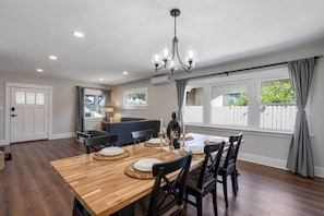 Enjoy meals in this stylish dining area with a wooden table and comfortable seating for four.