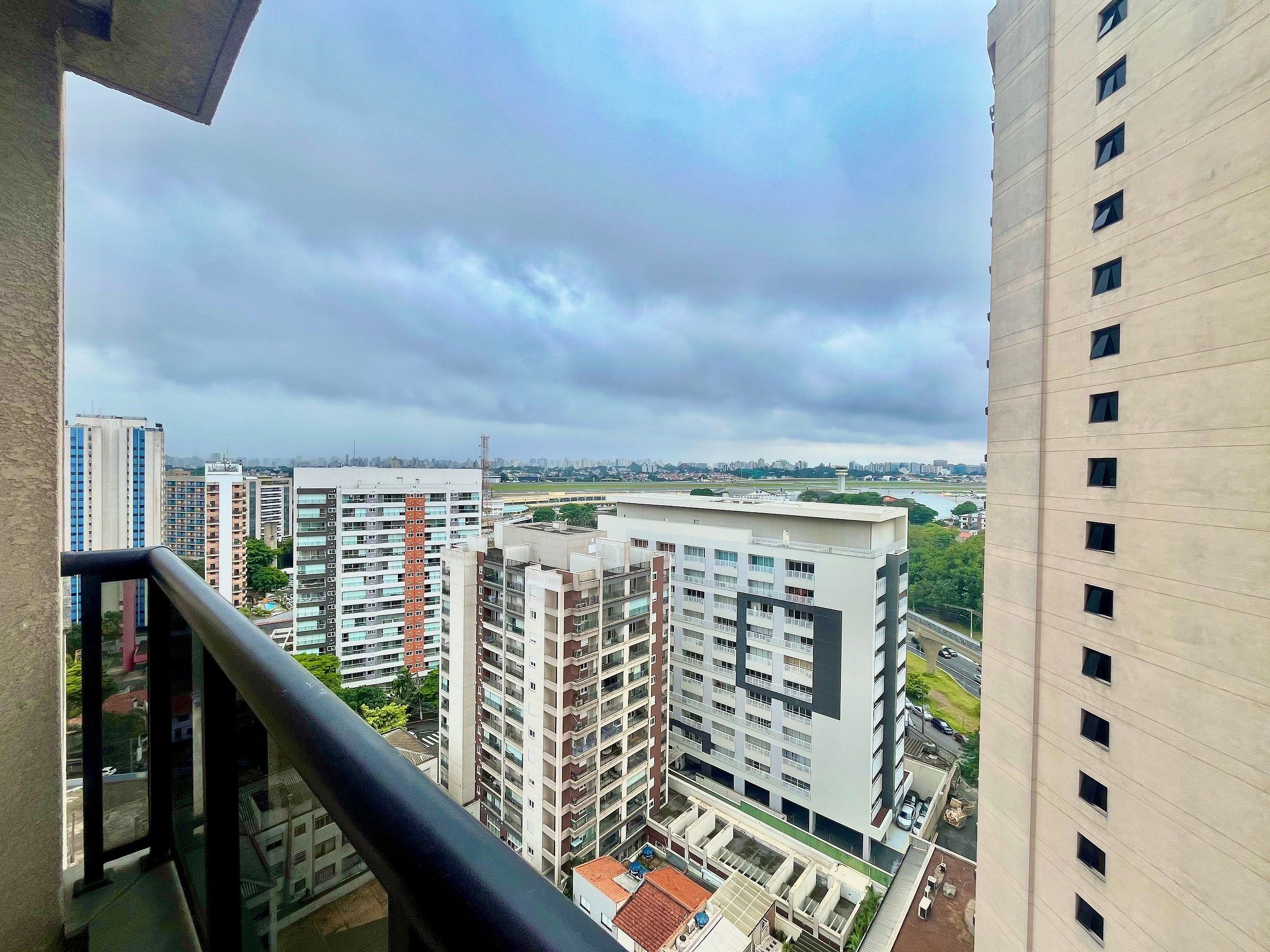 A high-rise building with multiple floors, large windows, and a view of the surrounding cityscape.
