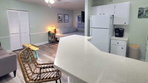 A compact living space with a kitchenette, a dining area, and a bedroom. - NEW! Ocean Breeze! 10 Steps 2 beach! Beach view! (Clearwater)
