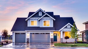 A two-story house with a garage, a well-maintained lawn, and a driveway. - Test  property (Redmond)