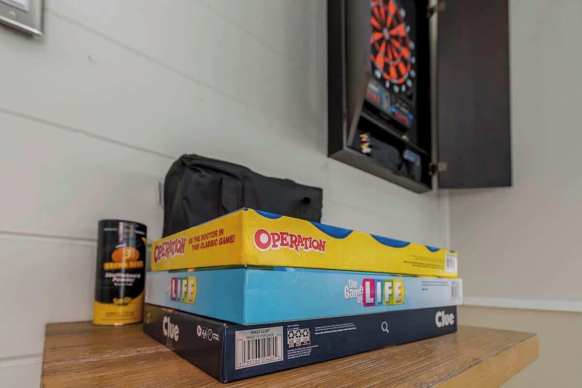 A game box labeled 'Operation' on a table with a dartboard in the background.