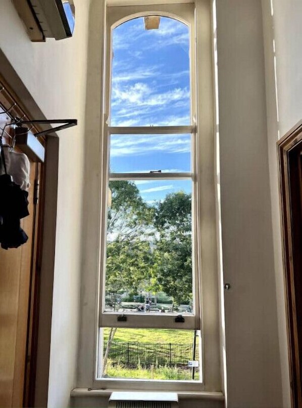 Enjoy a serene view of the lush landscape from this room's large window.