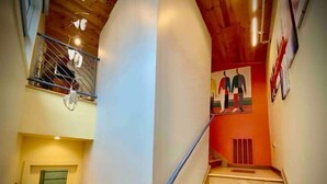 A staircase with a handrail, wooden steps, and a ceiling with recessed lighting. - The Lookout (Galeton)
