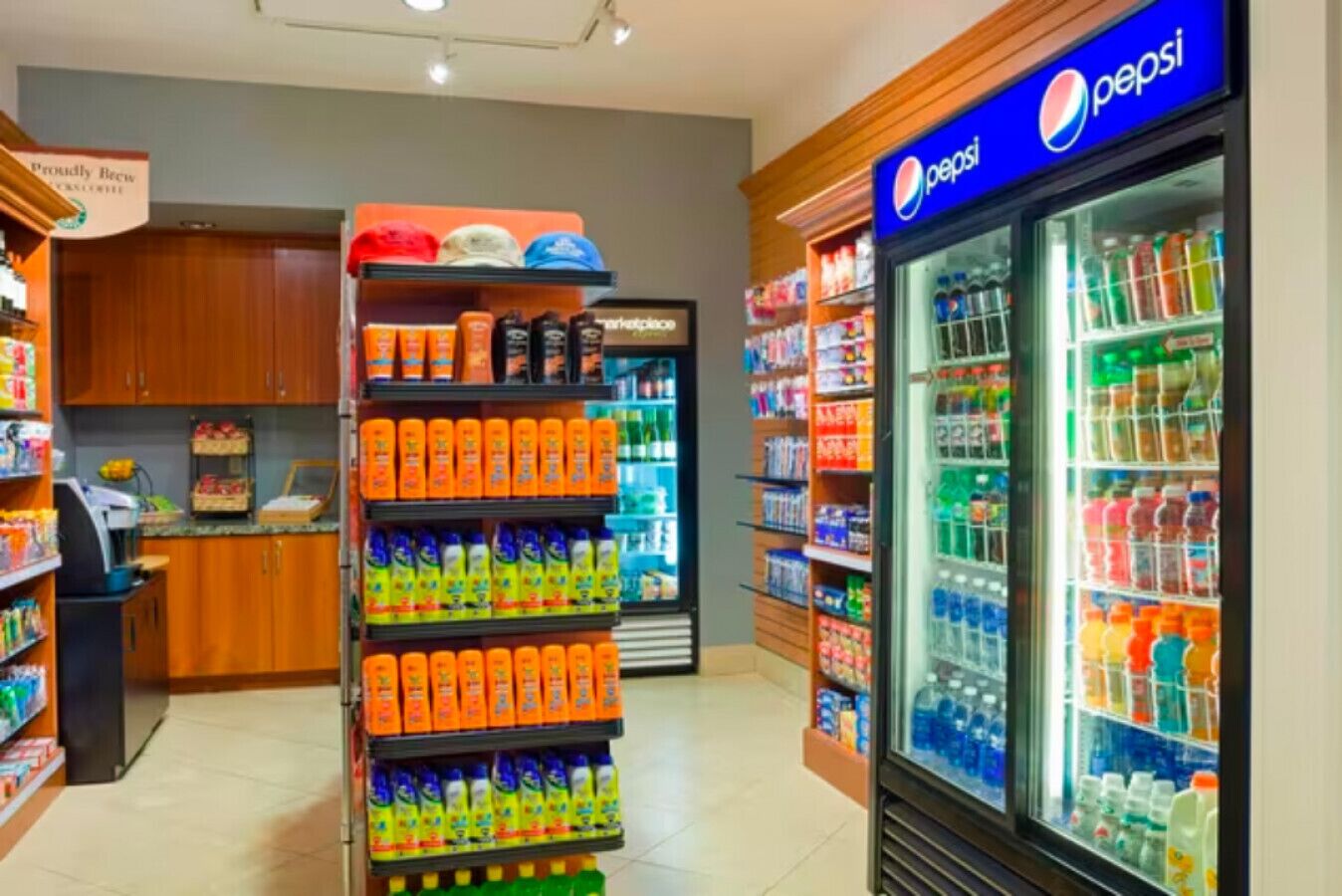 Una tienda de comestibles con un refrigerador de Pepsi y estantes llenos de diferentes bebidas.