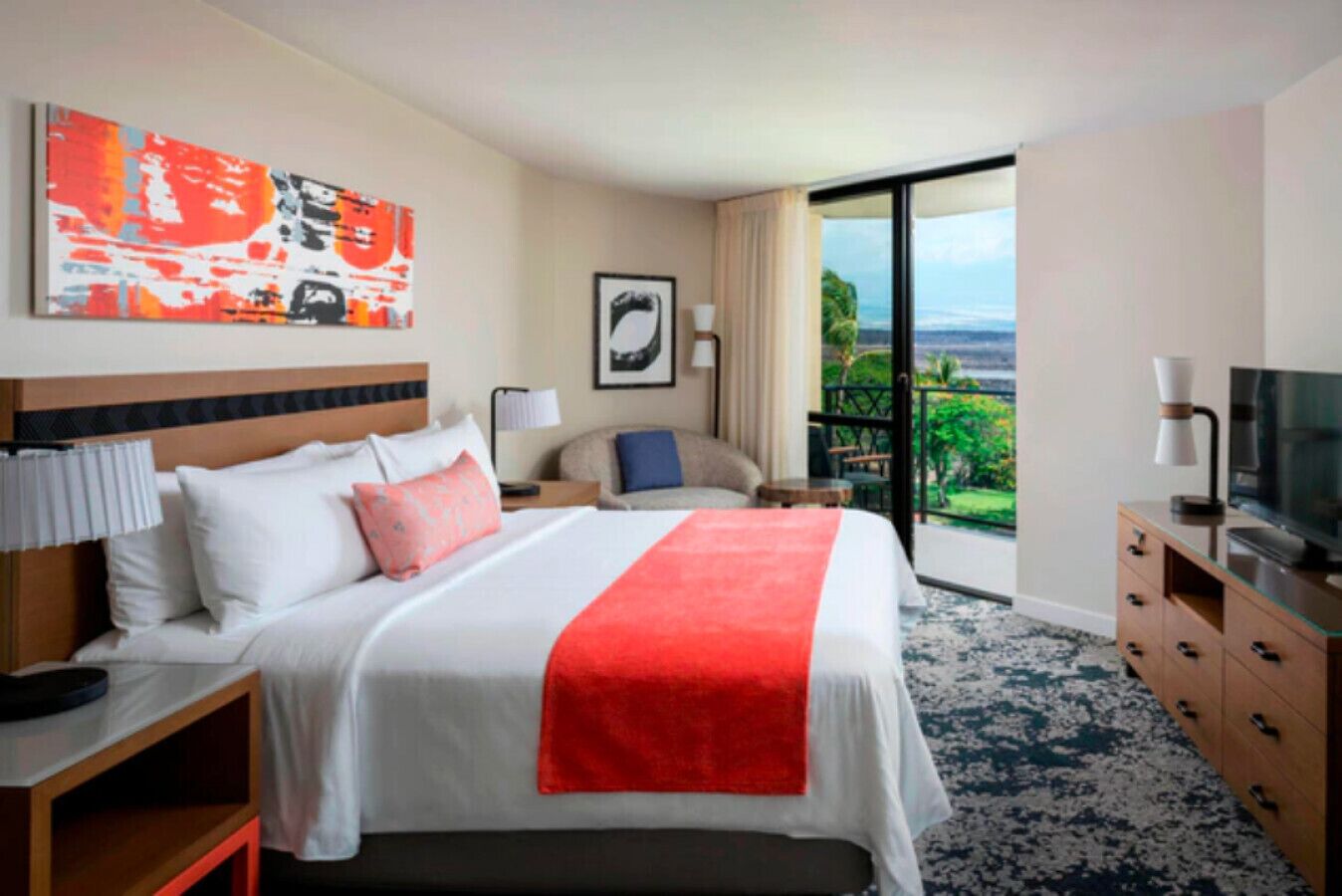 A hotel room with a bed, a television, a desk, a chair, a nightstand, a lamp, and a painting.