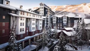 A hotel with multiple buildings, snow-covered trees, and a mountainous backdrop. - Marriott's MountainSide (1BR) (Park City)