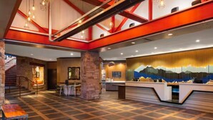 A spacious lobby with a high ceiling, exposed beams, a reception desk, and a staircase leading to another level. - Marriott's MountainSide (1BR) (Park City)