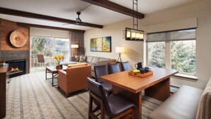 A spacious living area with a fireplace, a dining table with chairs, and a sofa. - Sheraton Mountain Vista Villas (2BR) (Avon)
