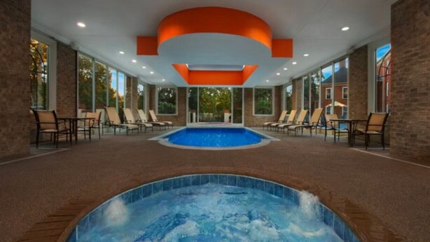An indoor swimming pool area with lounge chairs and a hot tub. - Marriott's Manor Club (2BR) (Williamsburg)