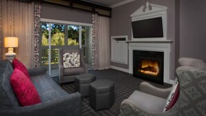 A cozy living room with a fireplace, a sofa, a chair, and a television. - Marriott's Manor Club (2BR) (Williamsburg)