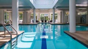An indoor swimming pool with clear blue water, surrounded by white pillars and large windows. - Marriott's SurfWatch (2BR) (Hilton Head Island)
