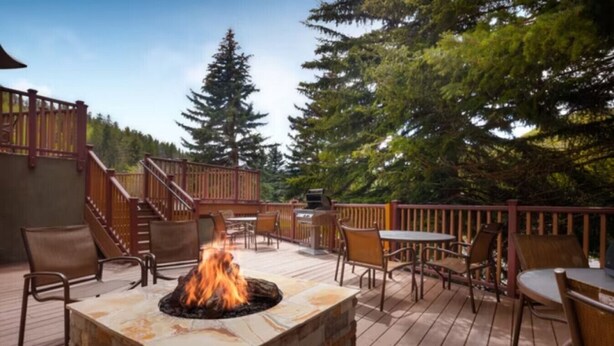 A deck with a fire pit, outdoor furniture, and a staircase leading to an upper level. - Marriott's StreamSide - Birch, Douglas & Evergreen (2BR) (Vail)