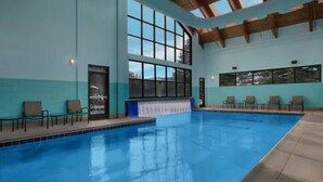 An indoor swimming pool with clear blue water, wooden beams on the ceiling, and several lounge chairs along the poolside. - Marriott's StreamSide - Birch, Douglas & Evergreen (2BR) (Vail)