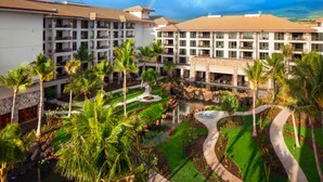 A resort with multiple-story buildings, a central water feature, and surrounding palm trees. - The Westin Nanea Ocean Villas (3BR) (Lahaina)