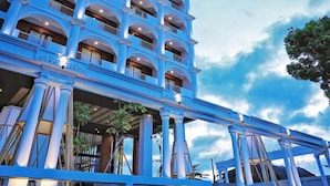 A multi-story hotel with a classical architectural style, featuring a central atrium with columns and balconies on each floor. - Patra Malioboro (Gedong Tengen)