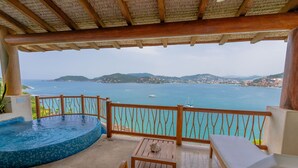 A balcony with a wooden railing, a small pool, and a view of the sea and hills. - Pacífica Grand Zihuatanejo (Zihuatanejo)