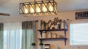 A kitchen with a central island, bar stools, a coffee sign, and a 'Farm' sign on the wall. - Bryce Canyon Cottage! Just a few of mins away. (Panguitch)