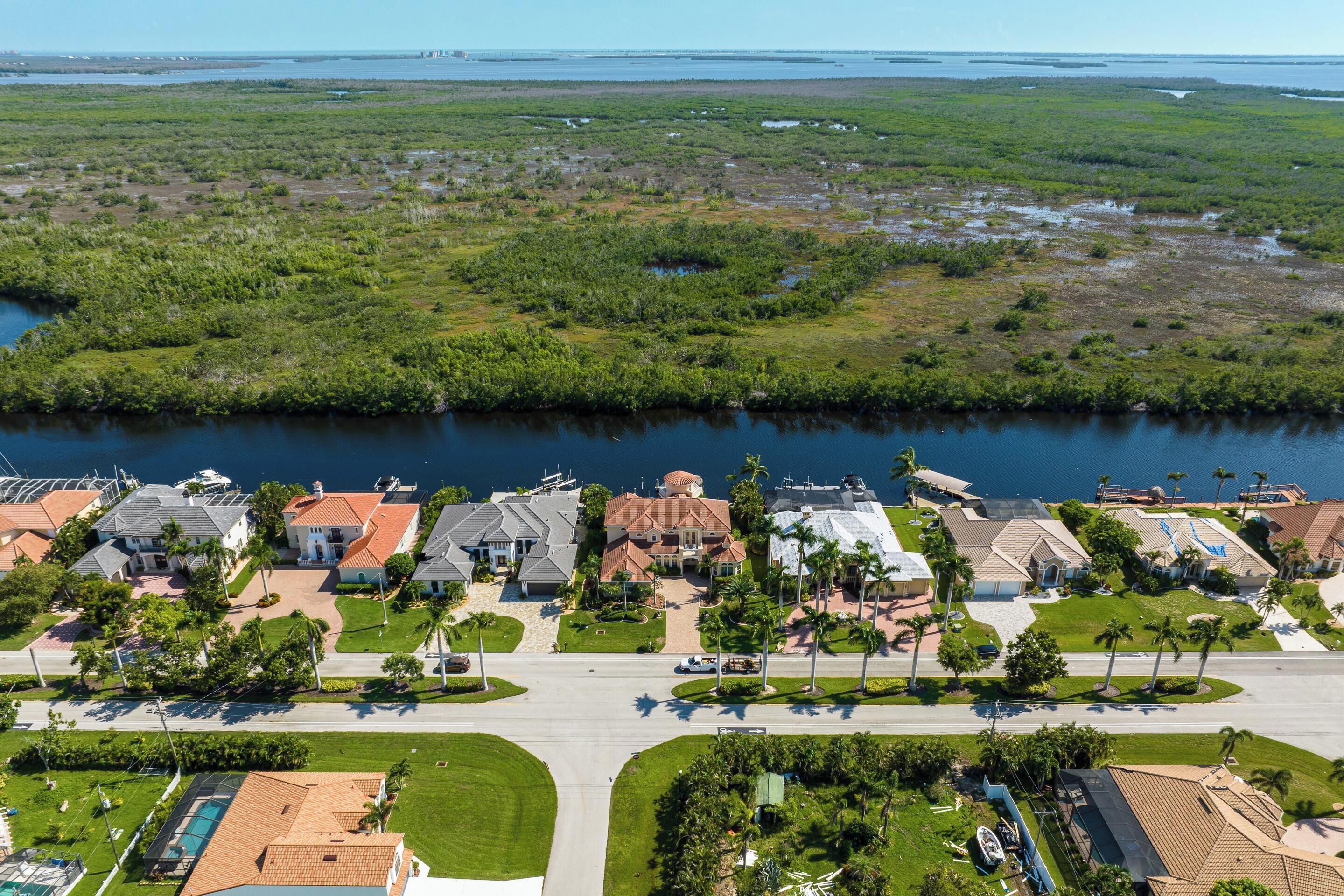 Un quartier résidentiel avec des maisons, une piscine et un accès au bord de l’eau.