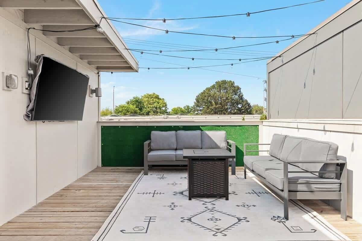 Beautiful rooftop with a fire pit and a TV
