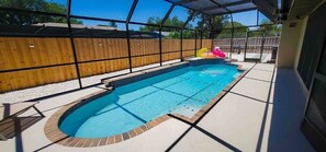 Relax by the rectangular pool surrounded by a light-colored deck.