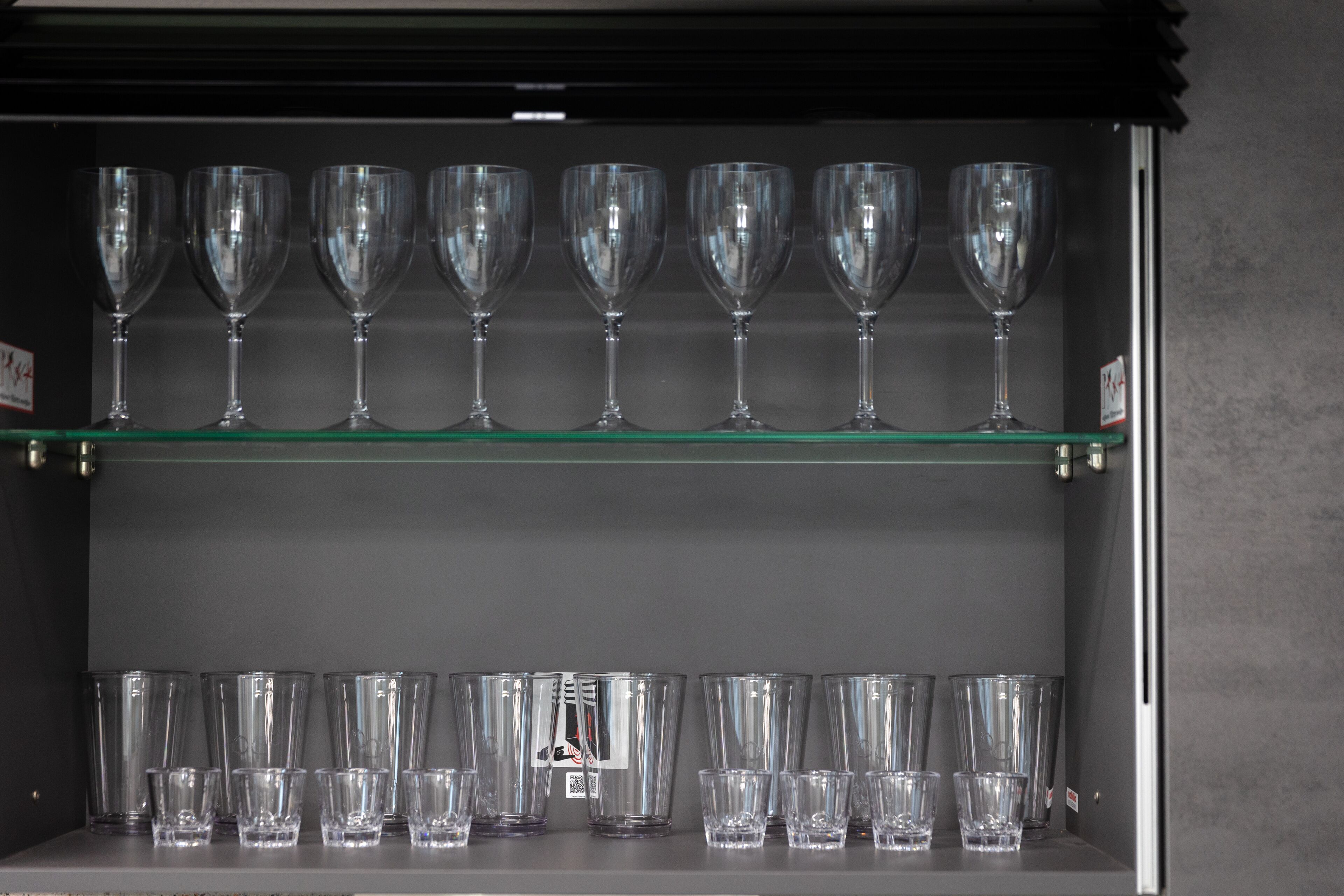 A display of clear glassware on shelves.