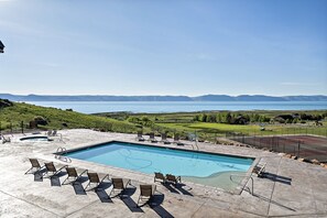 A swimming pool with lounge chairs and a view of a lake and mountains. - Spectacular views of Bear Lake in a spacious private retreat on nearly 6 acres! (Fish Haven)