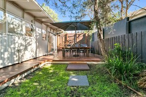 Enjoy al fresco dining on the deck, surrounded by lush greenery and a tranquil atmosphere.