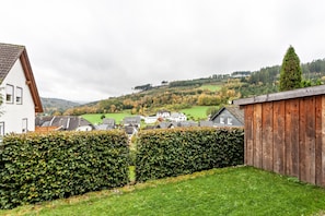 Un quartier résidentiel avec des maisons, une clôture en bois et une haie.