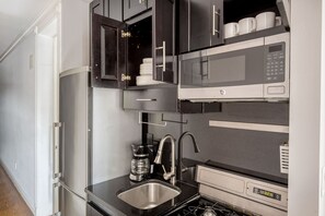 Fridge, microwave, oven, stovetop - Lovely Nolita 2BR w/ Balcony & W/D, nr Museum & Groceries, by Blueground (Downtown)