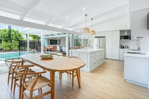 Enjoy meals in the spacious kitchen and dining area, featuring a large island and dining table for four.