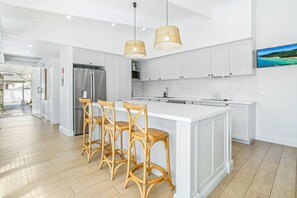 Enjoy cooking in this well-equipped kitchen with a large island, bar stools, and a flat-screen TV.