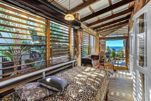 Relax in this inviting room with a large bed, ocean views, and a cozy seating area.