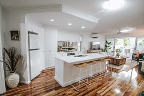 Enjoy cooking in this well-equipped kitchen with a central island, stainless steel sink, and oven.