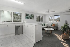 Enjoy a compact living space with a kitchenette, dining area, and comfortable sofa.