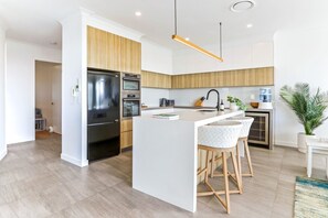 Enjoy cooking in this well-equipped kitchen with a central island and stainless steel appliances.