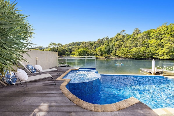 Relax by the serene pool surrounded by lush greenery and enjoy a refreshing swim or kayak on the calm waters.