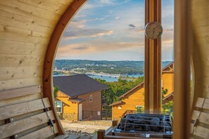 A wooden structure with a view of a bridge over water, surrounded by trees and buildings. - Lazy River, Pools, Lake View, Sauna, Sleeps 27 (Kimberling City)