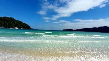 On the beach, white sand, sun loungers, beach umbrellas