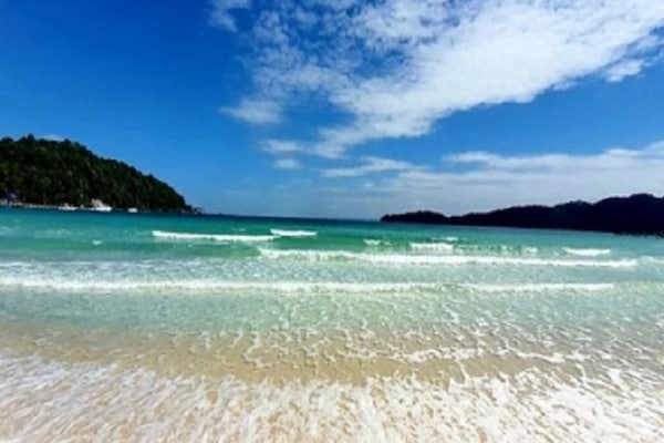 On the beach, white sand, sun loungers, beach umbrellas