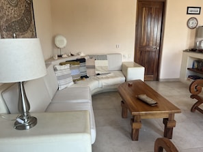 Relax in this stylish living room with a leather sofa, coffee table, and bookshelf.