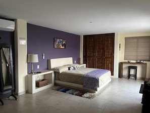 Cozy retreat with a large bed, bedside tables, and a wardrobe.