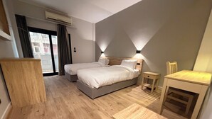 A hotel room with a bed, bedside tables, a desk, and a wardrobe. - Atlas Hotels (Cairo)