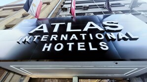 The exterior of the Atlas International Hotels building with its name prominently displayed. - Atlas Hotels (Cairo)