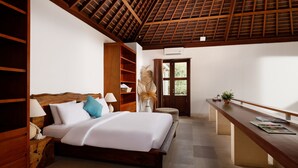 A bedroom with a wooden bed, a nightstand, a desk, and a window with curtains. - Omegia Canggu by Nakula (Canggu)