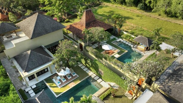A large property with multiple swimming pools, lush greenery, and traditional architecture. - Omegia Canggu by Nakula (Canggu)